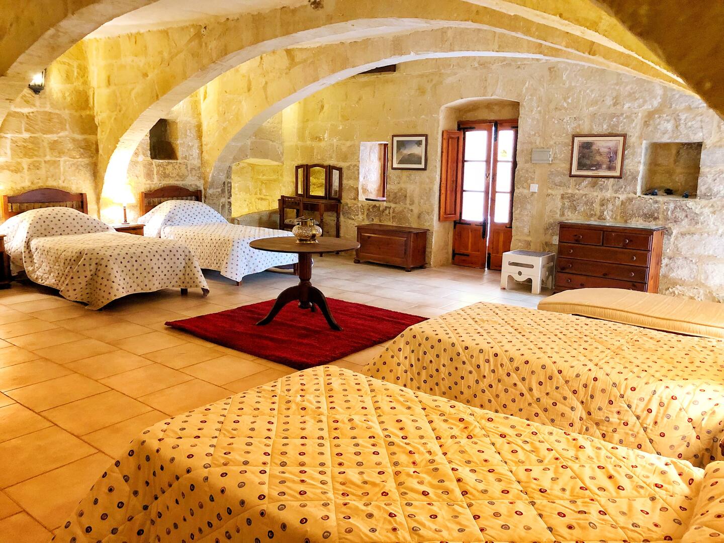 Stone arches and four single beds in the mill room